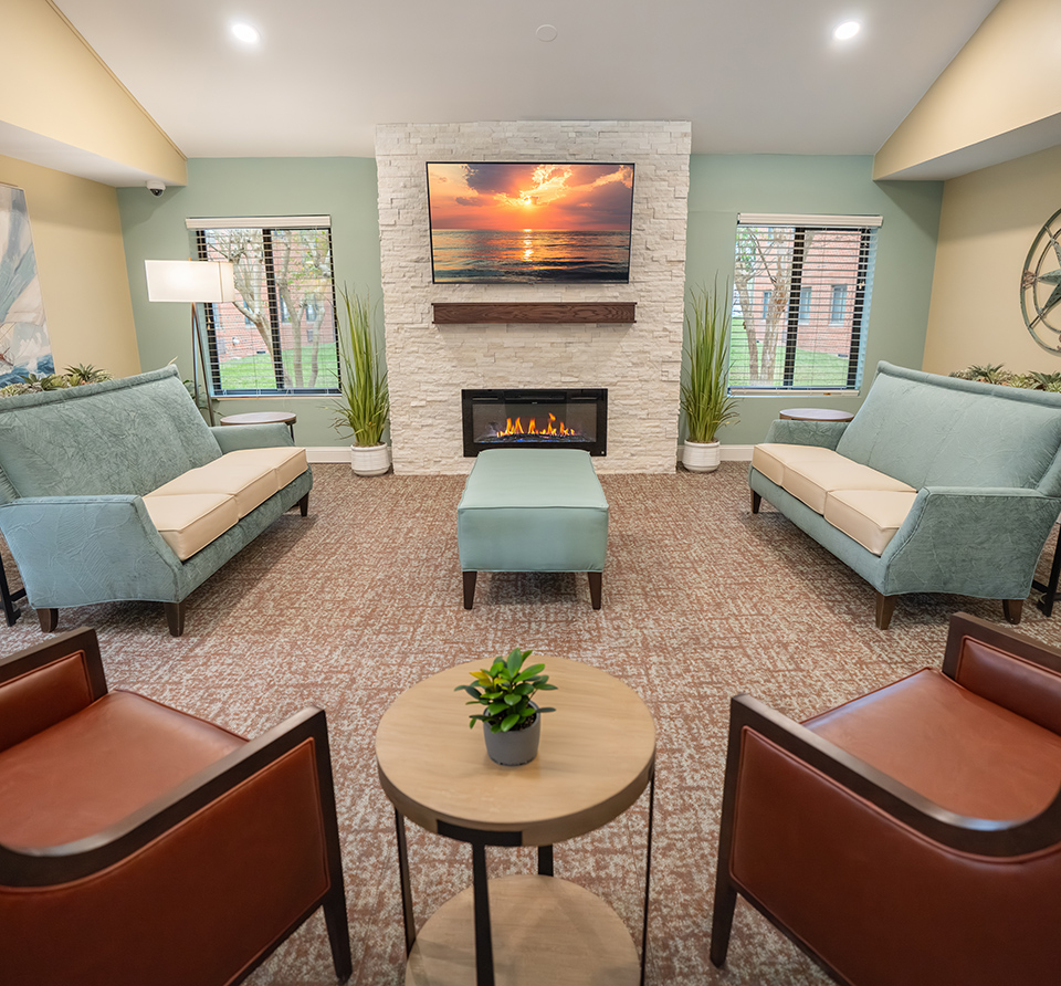 Russell House living room with large TV, fireplace, seating, and great views